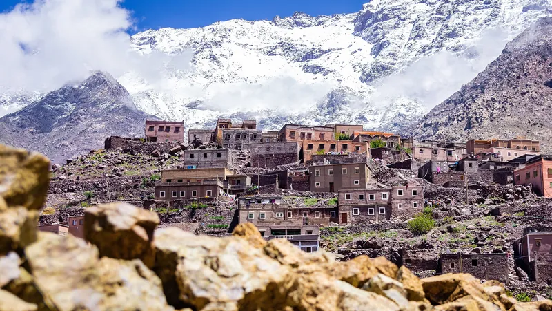 Berber village of Aroumd near Imlil, mud-brick houses at the foot of the snow-capped Toubkal peaks